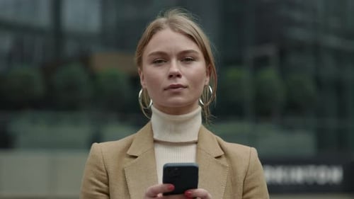 Business Woman Standing on Street and Using Smartphone