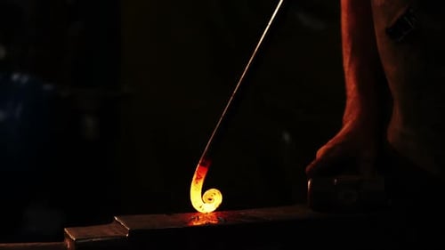 Blacksmith Shaping Red Hot Metal on Anvil