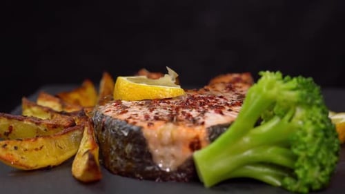 Prepared Salmon with Potato Wedges and Broccoli
