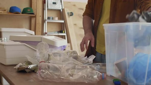 Unrecognizable Man Sorting Different Garbage in Sorting Center