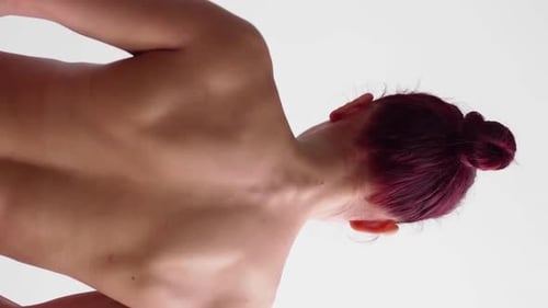 Woman With Dark Hair Posing in Studio