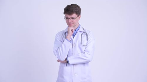 Thoughtful Doctor in White Coat Standing