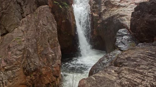 Foamy Cascade Waterfall To Deep Pool Among Rocks
