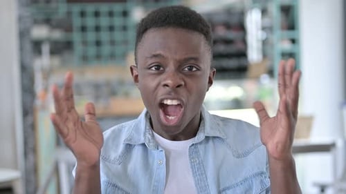 Young Adult Shouting in Anger, Close Up