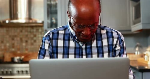 Stressed senior man using laptop