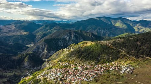 Aerial View of Village in Valley Surrounded by Mountains
