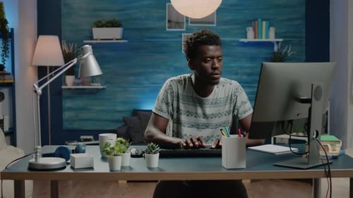 Young Adult Computing at Desk at Home