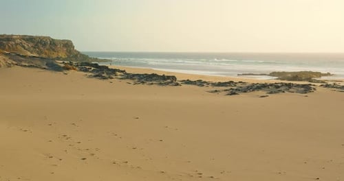 Deserted Tropical Beach White Sand Turquoise Ocean and Waves Against the Background of Stones