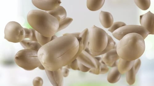 Shelled Peanuts Floating Against Blurred Background