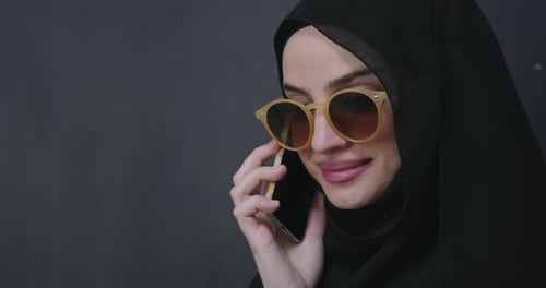 Modern Muslim Woman Using Smart Phone