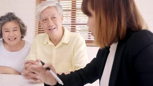 Senior Couple Meeting with Financial Advisor at Home