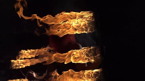 Female Fire Performer Dances with Vibrant Flames
