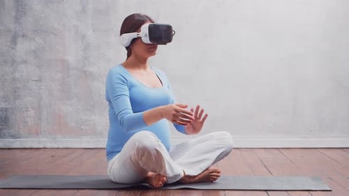 Pregnant Woman Using VR Headset at Home