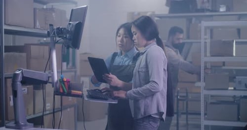 Workers Checking Information on Computer