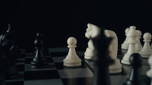 Strategic Chess Pieces on a Black and White Board