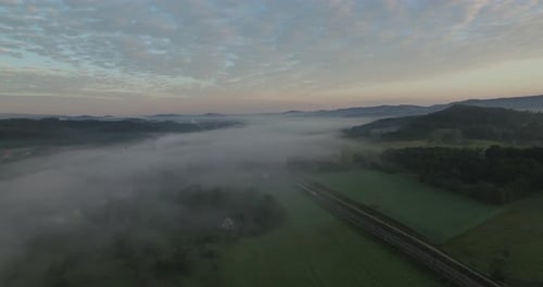 Sunrise Aerial View of Rural Landscape with Train