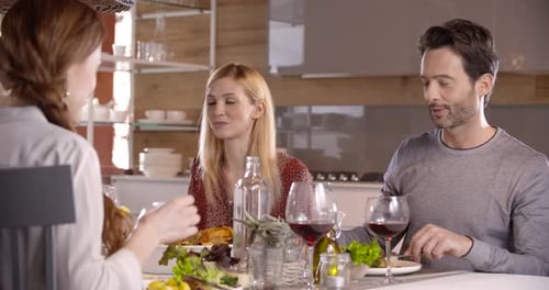 Friends Sharing Meal Together Indoors at Home