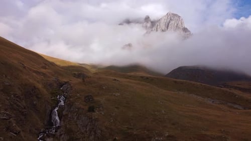 Foggy Peak And Mountain Waterfall