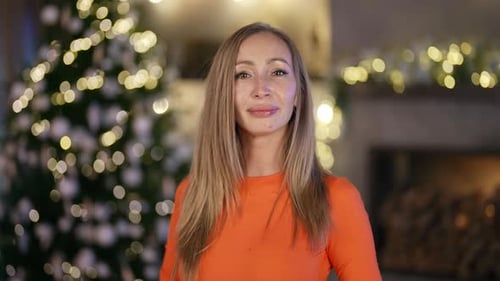 Smiling Woman in Front of Christmas Tree