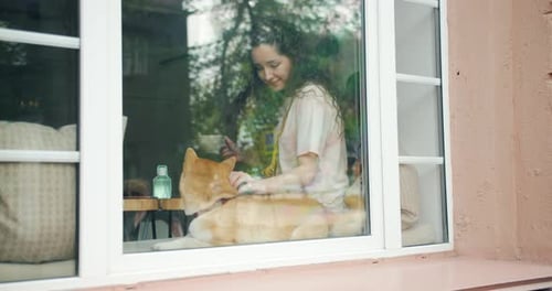 Woman Puts Dog Inside Home Through Window