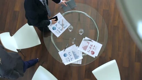 Business Meeting With Charts and Graphs