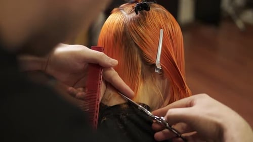 Hairdresser Cuts Vibrant Orange Hair in Salon