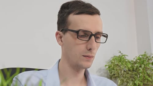 Man With Laptop In Her Office At The Desk Working