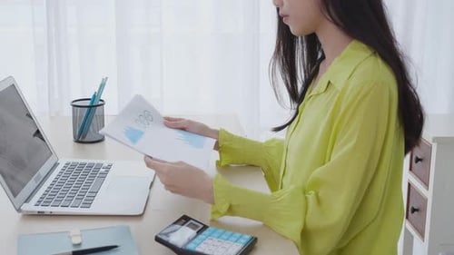 Young Adult Analyzing Data at Home Office