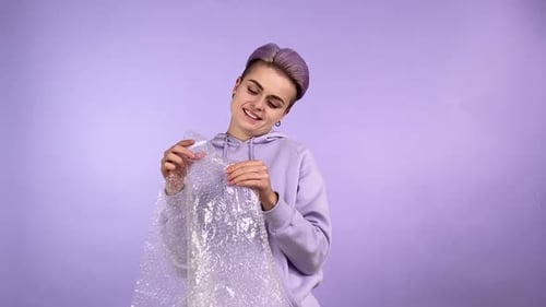 Smiling Young Adult with Bubble Wrap