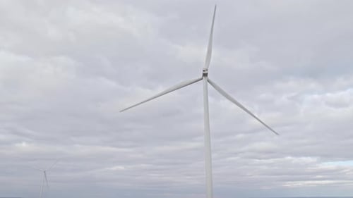 Rotating Windmill on Overcast Sky Background