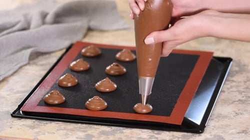 Piping Chocolate Cookie Dough Onto Baking Sheet
