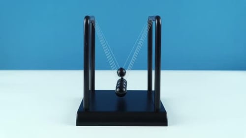 Newton's Cradle Demonstrates Kinetic Energy and Momentum
