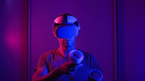 Man Exploring Virtual Reality with Headset and Controllers