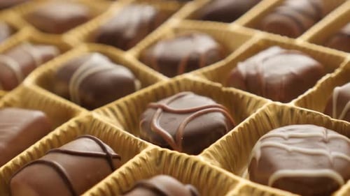 Assorted gift set tasty dessert background 4K 2160p 30fps UltraHD footage - Golden package chocolate