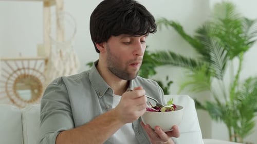 Young Adult Eating a Healthy Salad at Home