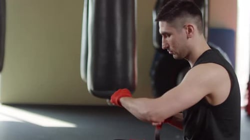Young Adult Boxer Wraps Hands at the Gym