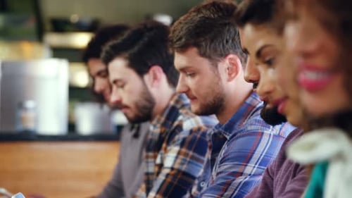 Young Adults Using Technology in Modern Cafe