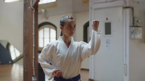 Woman Practices Karate in Bright, Open Studio