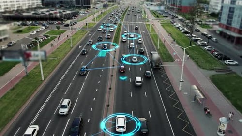 Robotic cars are controlled by AI, driving along a busy city avenue, scanning the road with sensors.