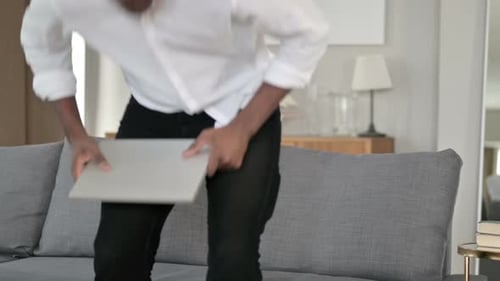 Young Adult Using Laptop on Couch