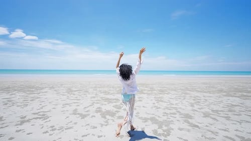 4K Portrait of Beautiful African woman walking on tropical beach in summer sunny day.