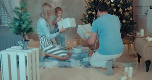 Family Celebrates Christmas and Opens Presents