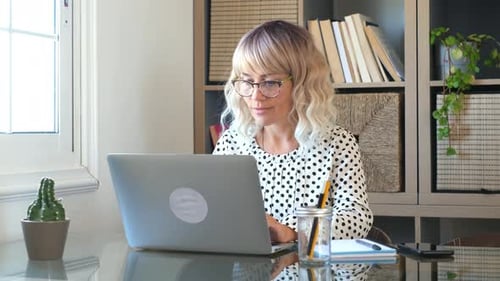 Young businesswoman write on laptop computer at home in smart working office job work activity