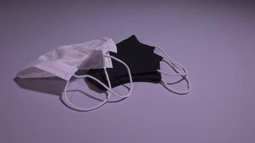 White and Black Face Masks on Table