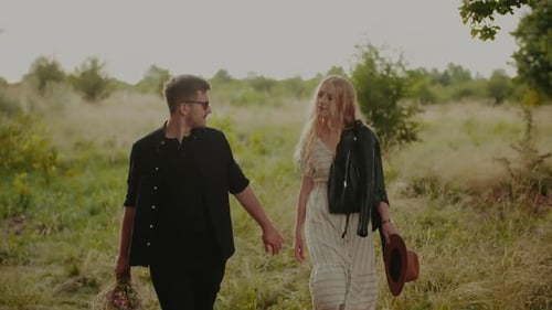 Carefree Young Couple Walking and Smiling on Holiday on Countryside Freedom and Happiness Concept