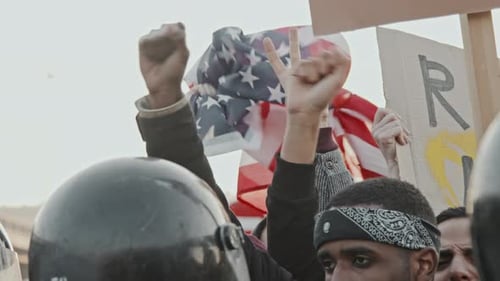 Demonstration with Protesters Holding Signs and Raising Fists