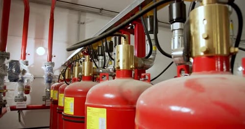Close Up of the Big Red Gas Cylinders Connected To the Pipe System