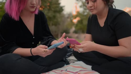 Girls in the Public Park Using Smartphones and Texting on It Close Up View