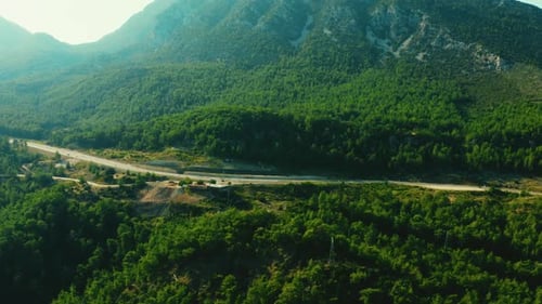 Aerial View From Above of Country Road Through Wooded Mountains