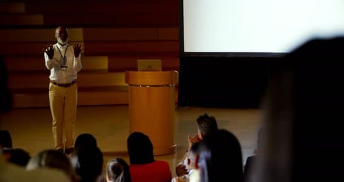 Mature African american businessman speaking in business seminar in auditorium 4k